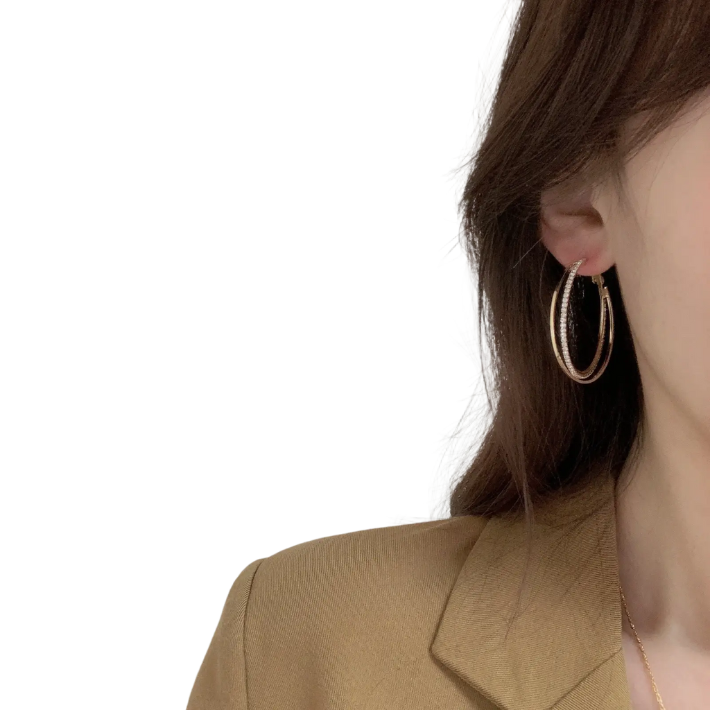 Double layered crystal pave hoop earrings in gold tone with delicate sparkling edges for elegant wear
