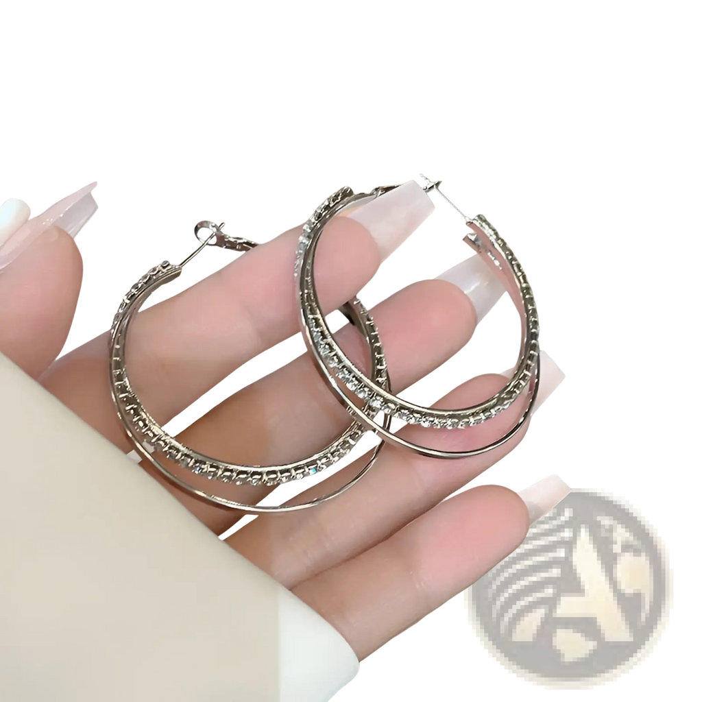 Silver double layered hoop earrings with sparkling rhinestones along the outer edge for elegant wear