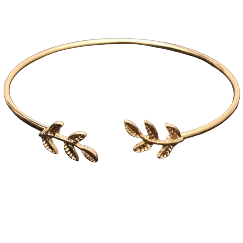 Gold-toned double ring metal bangle bracelet with intricate leaf and branch designs in an open style