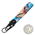 Blue fabric keychain with printed anime character goku wearing red goggles attached to black metal clip and ring