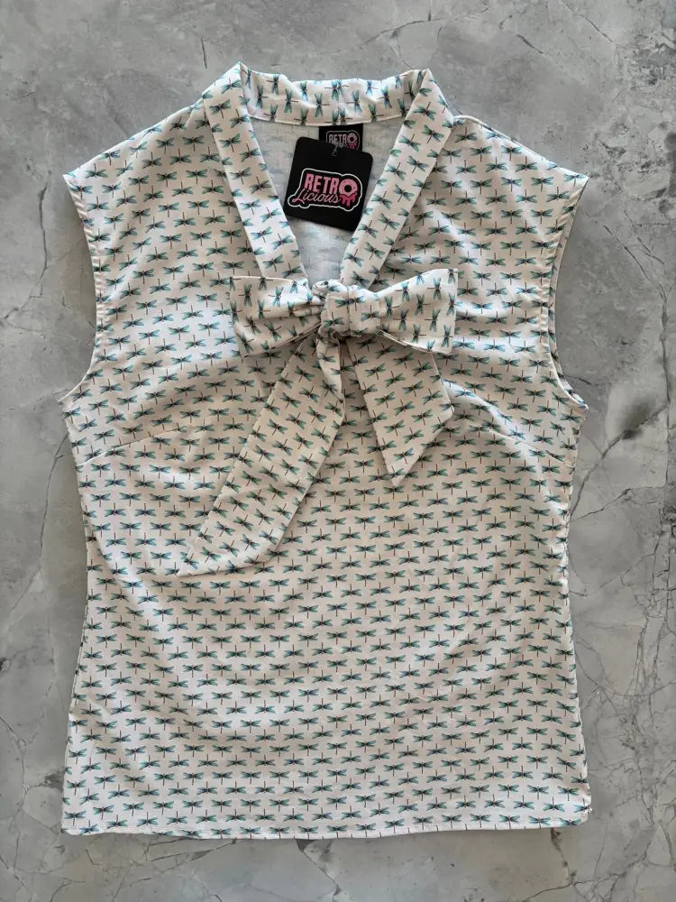 White cotton sleeveless retro legends blouse with dark green dragonfly pattern and matching bow at the neckline