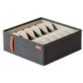 Dark gray fabric drawer organizer box with orange handle and red storage label holding beige and light green bras
