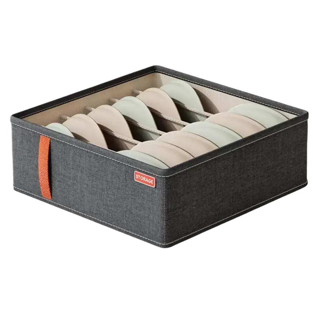 Dark gray fabric drawer organizer box with orange handle and red storage label holding beige and light green bras
