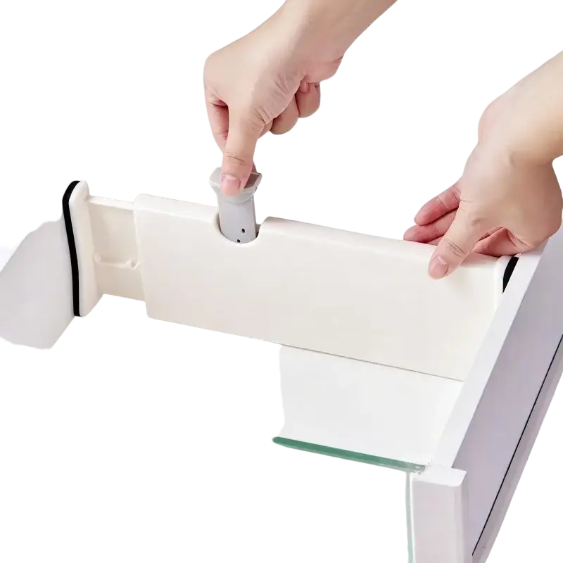 White plastic adjustable drawer partition with gray handle being installed into a white drawer for organized storage
