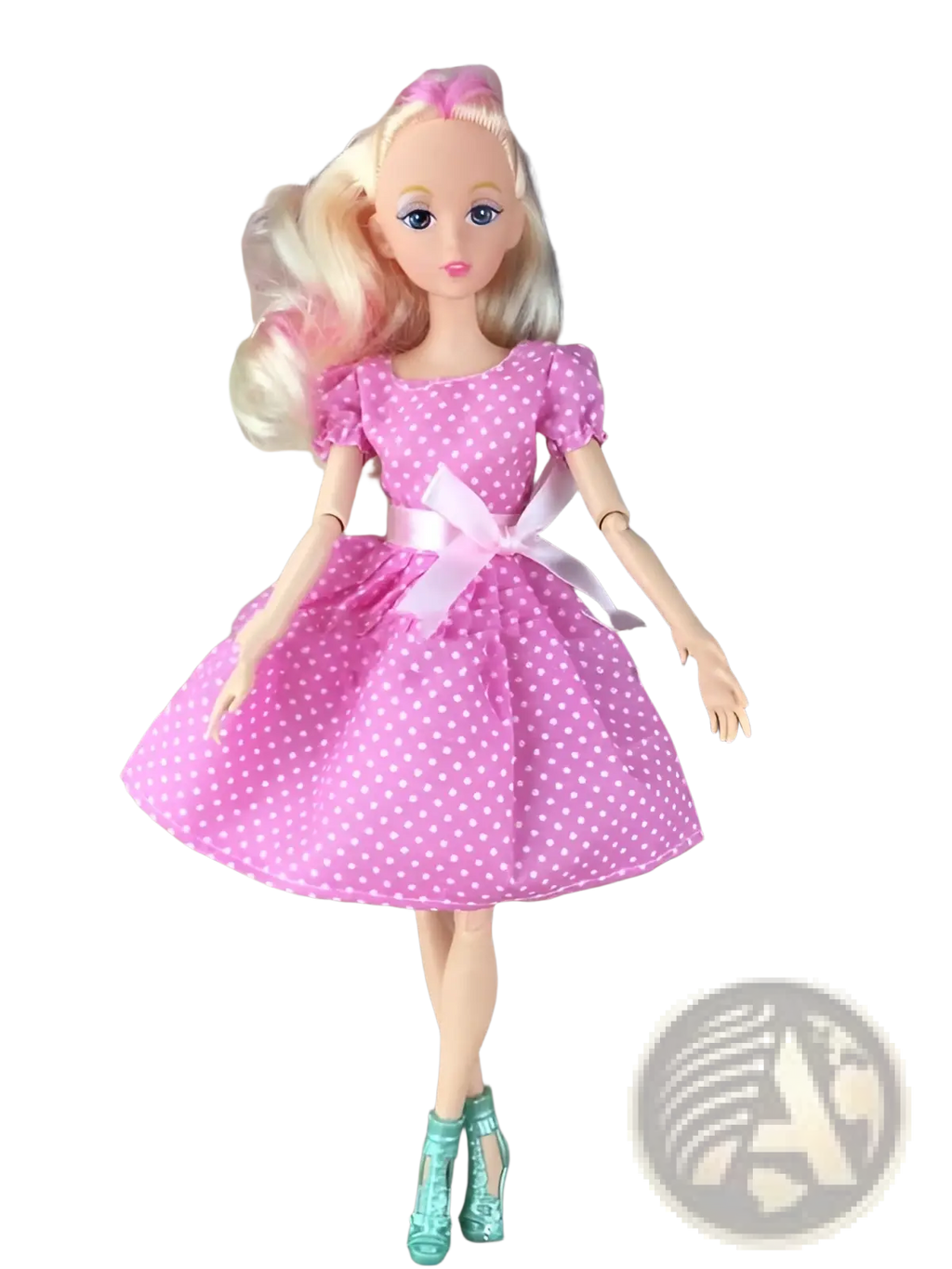 A blonde barbie dress up doll in a pink polka dot fashion suit with puffed sleeves and teal high heeled boots