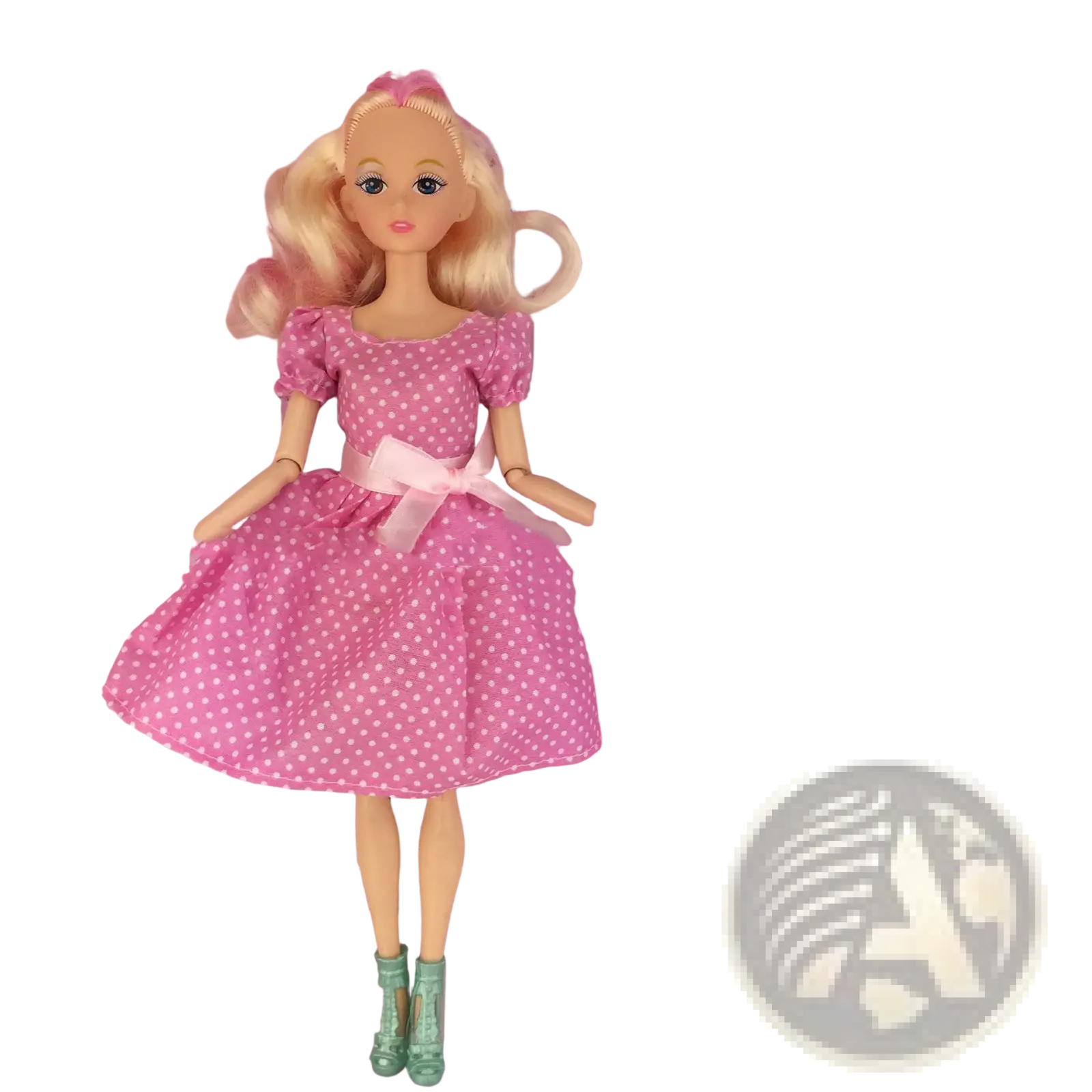 A blonde dress up doll wearing a pink polka dot fashion suit dress with a matching bow and light green boots
