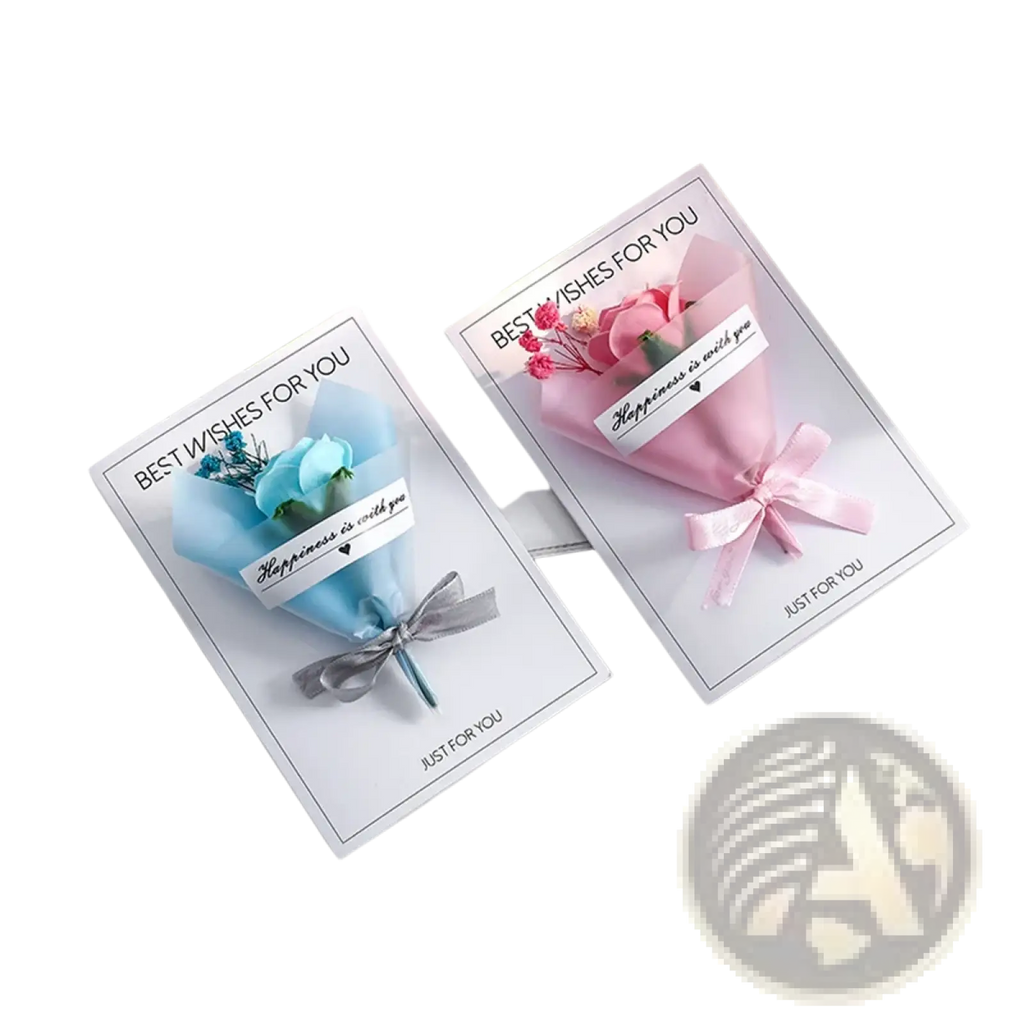Two handmade dried flower greeting card gift bouquets wrapped in pastel paper with matching ribbon bows on white cards