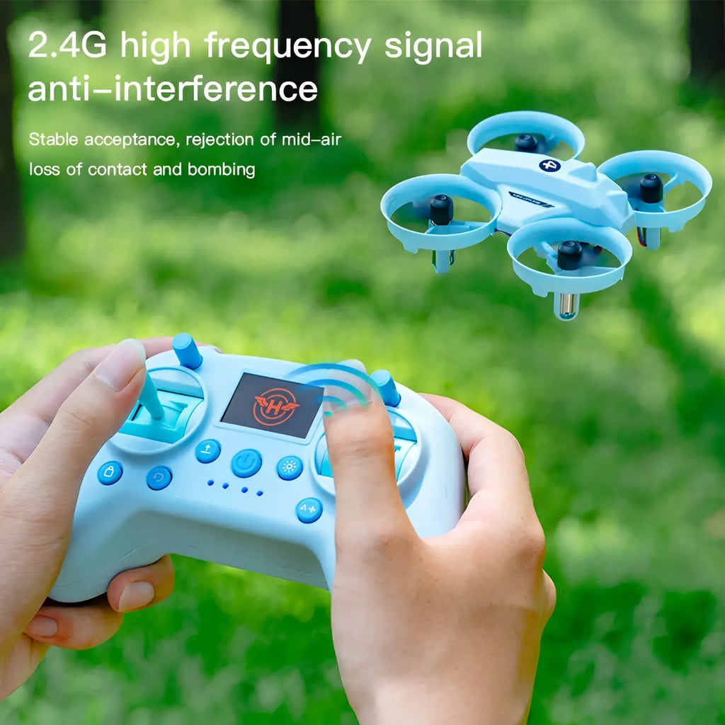 Light blue plastic drone simulator controller with small screen and multiple buttons paired with matching quadcopter drone
