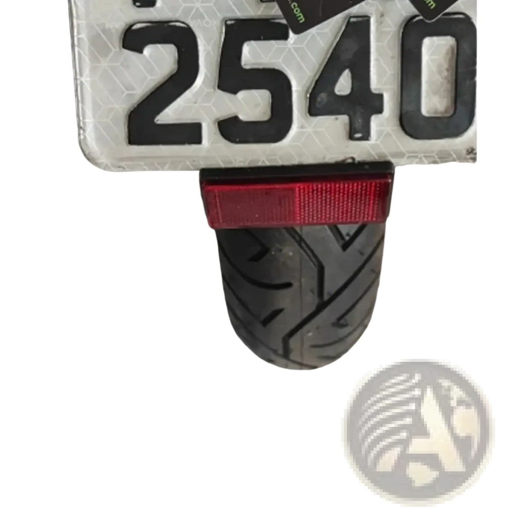 Back side of ducati monster 950 fender eliminator license plate holder with red rectangular taillight mounted on rear tire
