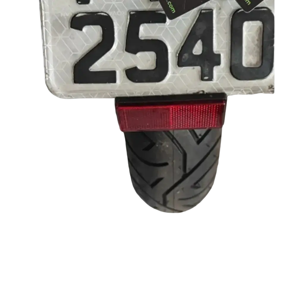 Back side of ducati monster 950 fender eliminator license plate holder with red rectangular taillight mounted on rear tire