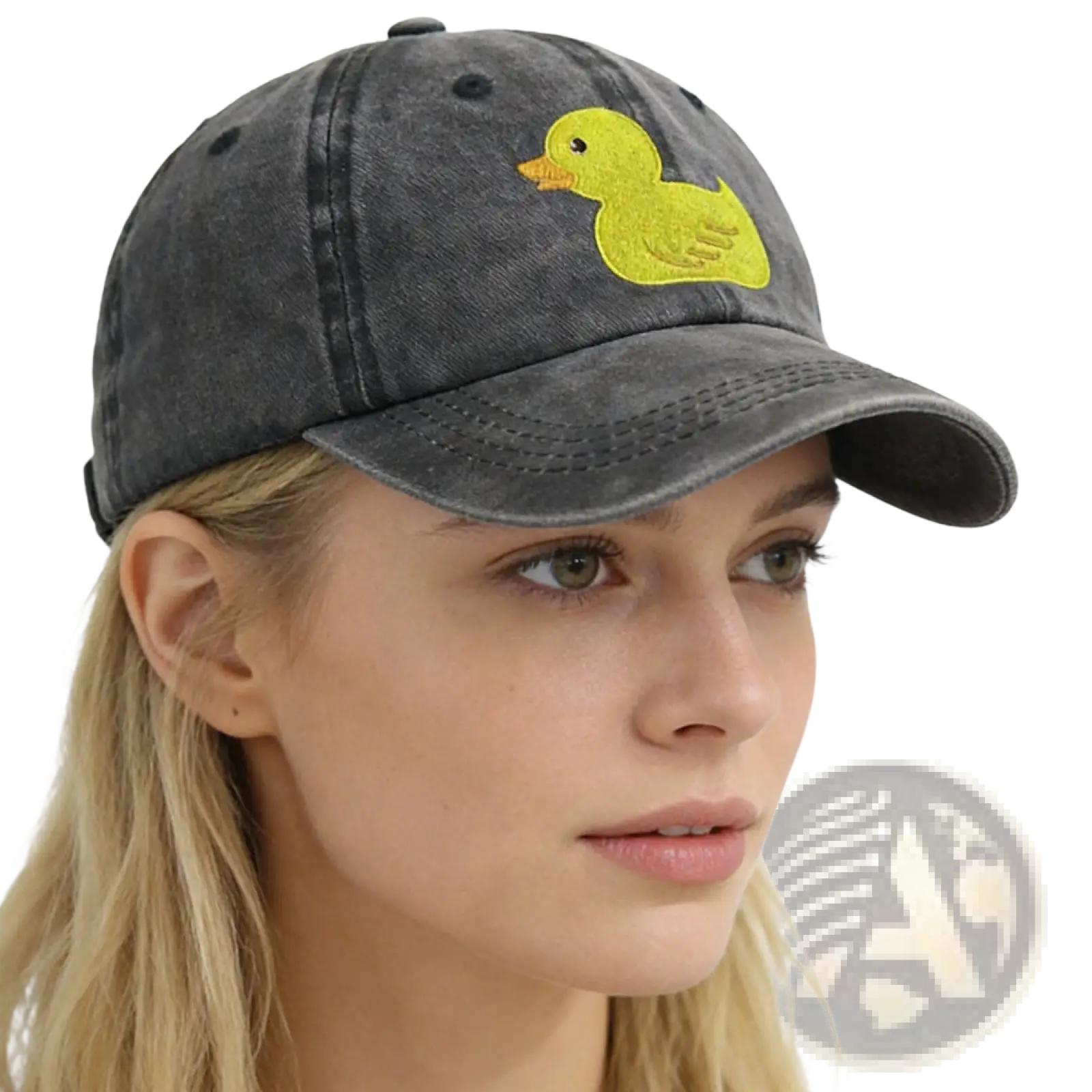 A faded gray distressed denim baseball cap featuring a bright yellow embroidered duck on the front