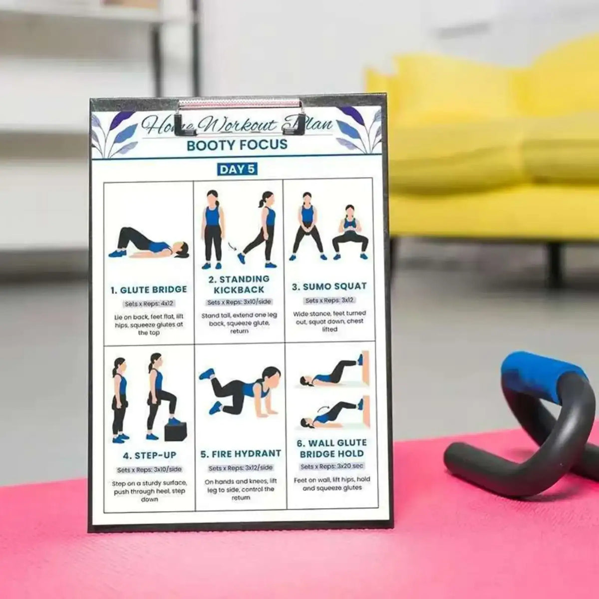 A black-framed clipboard with a home workout plan on white paper featuring boot focus exercises in dumbbell workout poster set