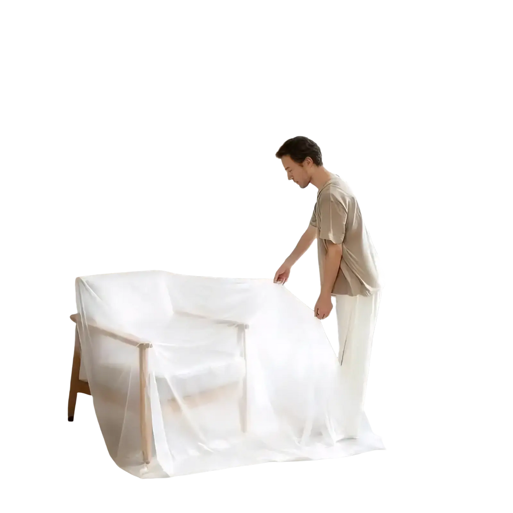 A minimalist wooden armchair covered with a sheer white dustproof furniture protection film from 3 rolls set
