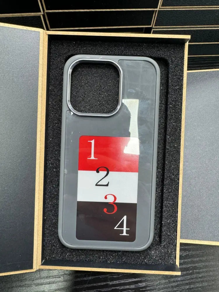 Gray personalized e-ink smart display luxury phone case back with red white black stripes and numbers 1 to 4 in contrasting colors