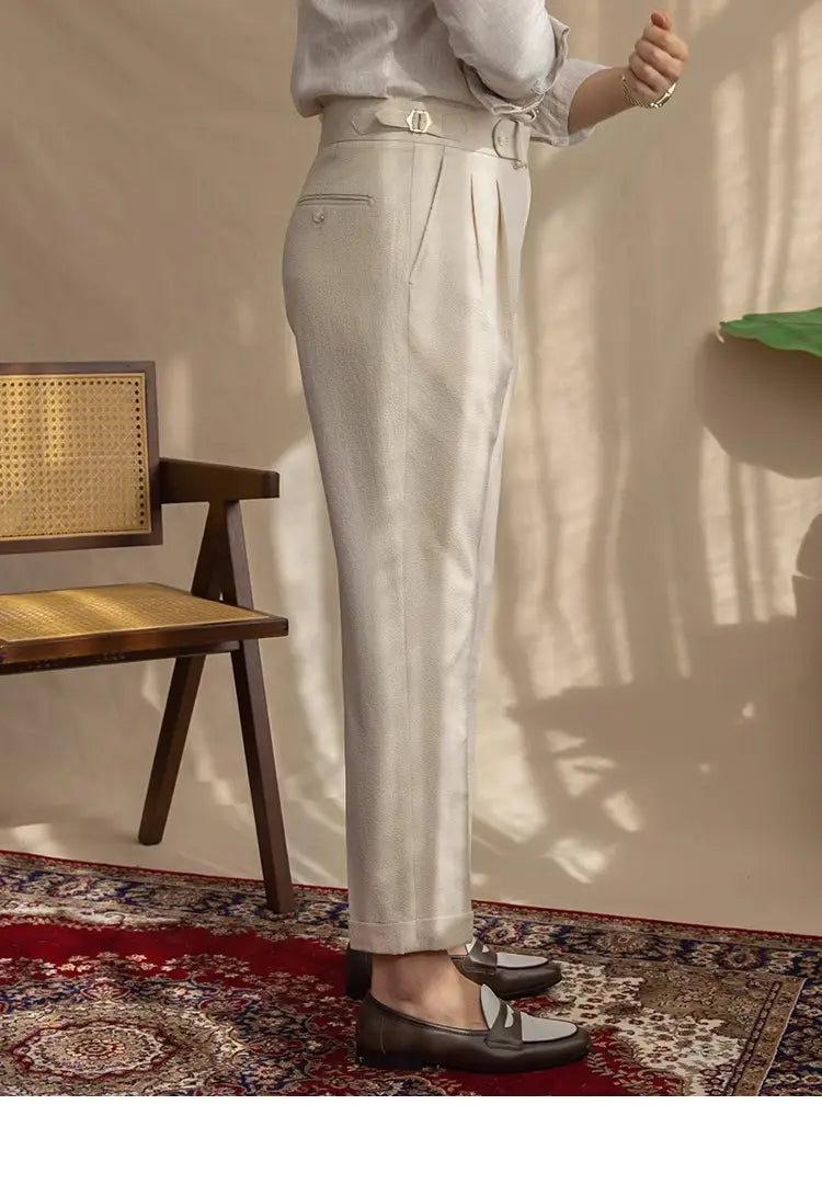 Men’s slim fit pleated summer linen suit trousers in light beige with a matching belt featuring a small metallic buckle.