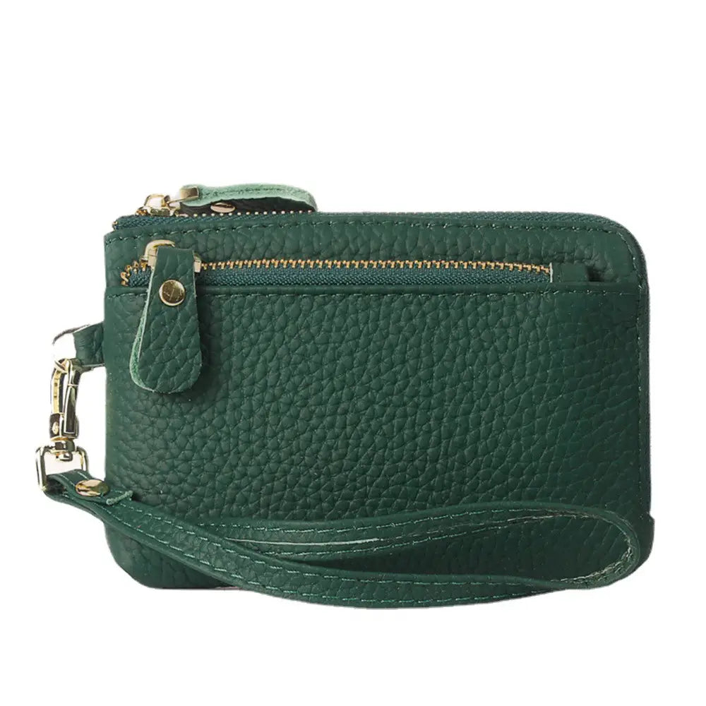 Dark green pebbled leather wristlet wallet with gold hardware featuring gold-tone zippers and a detachable strap.
