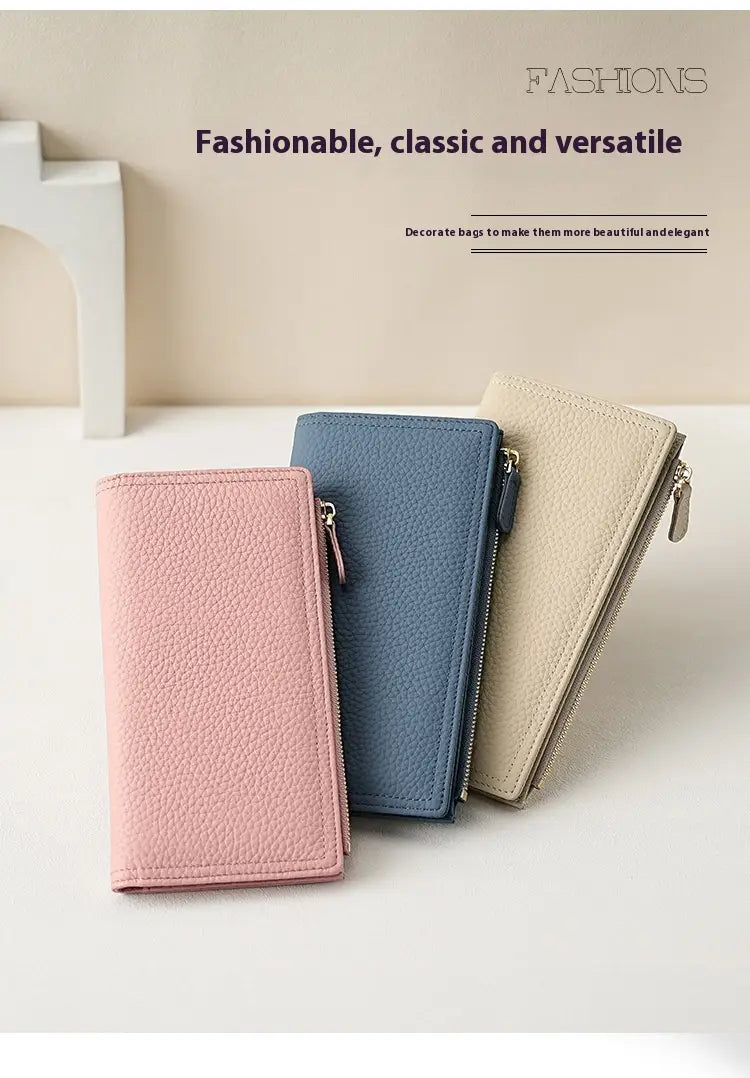 Three slim cowhide leather anti theft RFID long zip wallets in pastel pink blue and beige with matching zipper pulls.