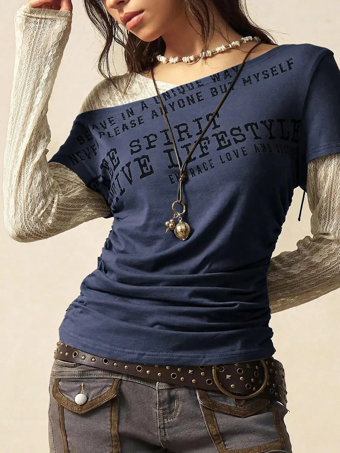Navy blue lace layer off shoulder knitted top featuring sheer beige lace long sleeves and black printed text across the chest.