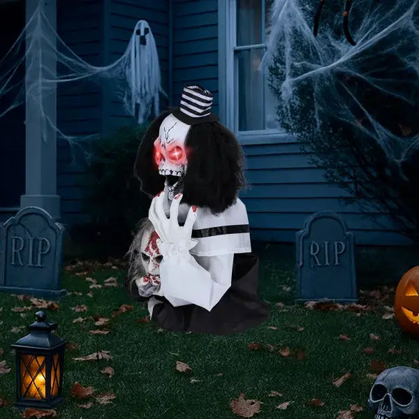 Scary clown halloween decoration 1.8ft featuring a black and white skull with glowing red eyes wearing a striped top hat and holding a smaller skull, sound activated.