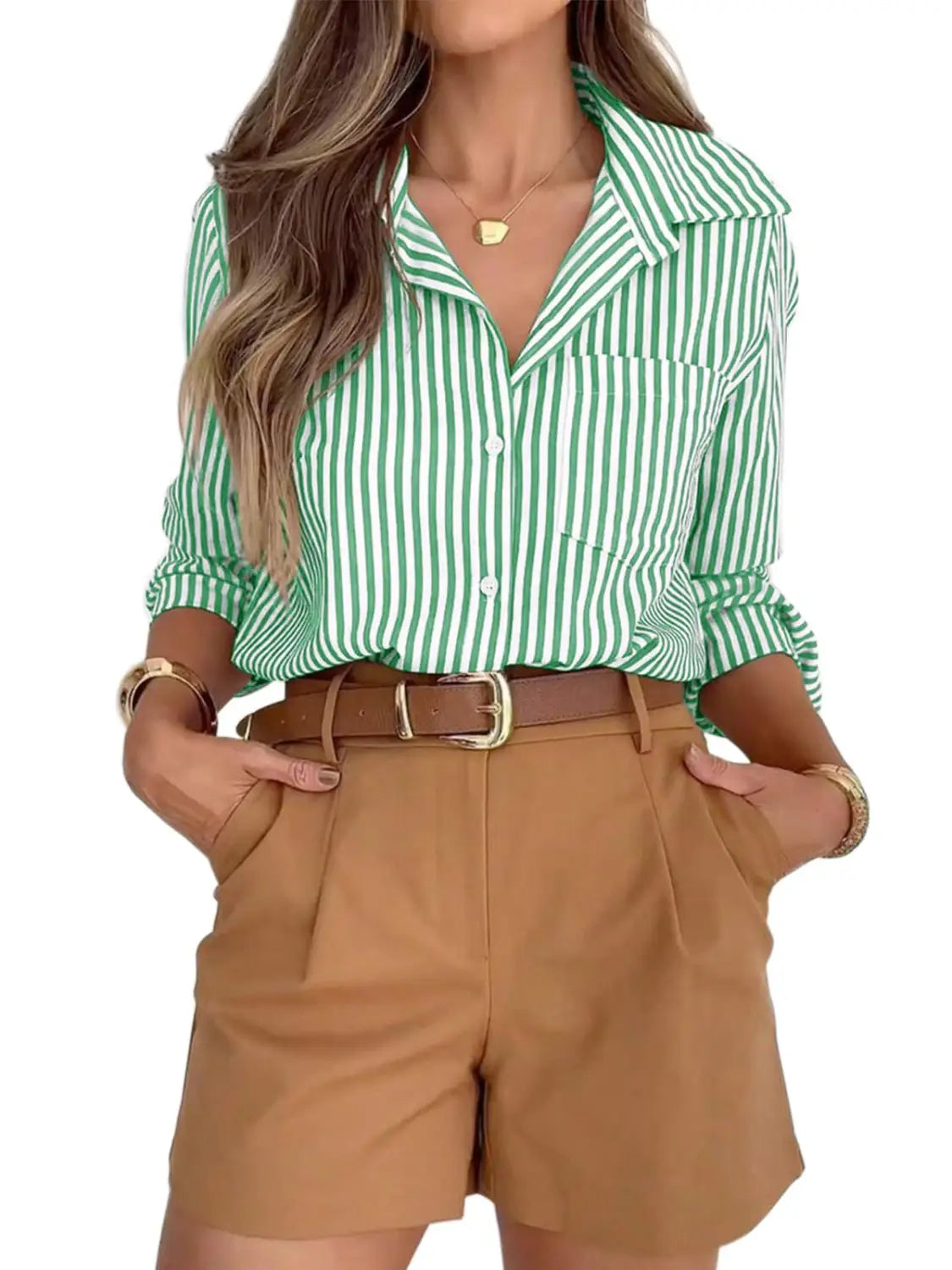 A green and white vertically striped women’s long sleeve button up shirt dress with rolled up sleeves.