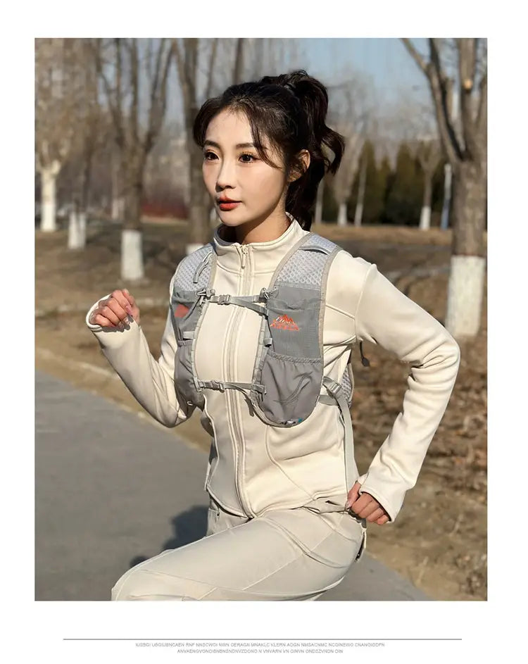 gray mesh and nylon hydration backpack lightweight running vest with 20l capacity and red logo on the chest