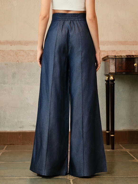 High waisted wide leg trousers in navy blue with a subtle textured fabric and an elastic waistband.
