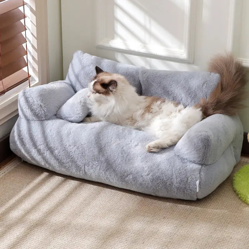 Soft light blue plush cat sofa bed with a cozy cushioned design ideal for warm winter pet lounging.