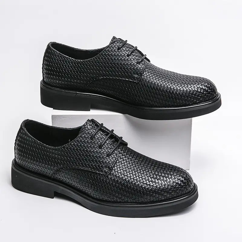 Men’s woven leather platform British dress shoe in black with lace-up design and solid rubber sole.