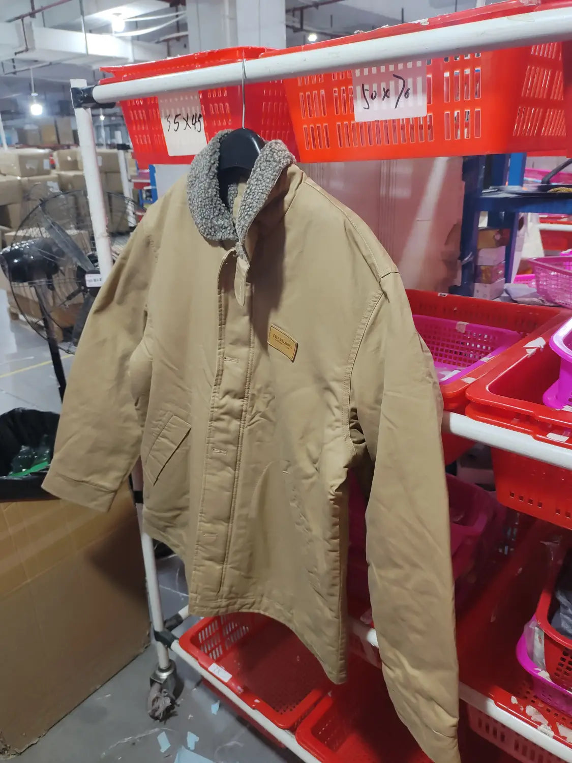 Mens fleece lined winter cotton jacket in tan corduroy with a gray fleece lined collar and a small brown leather patch on the chest