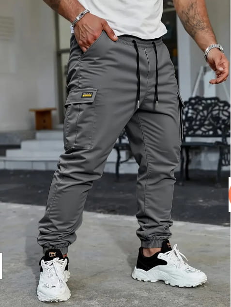 Men’s slim fit cropped gray cargo joggers with black drawstrings and a small yellow logo on the thigh pocket designed for casual wear.
