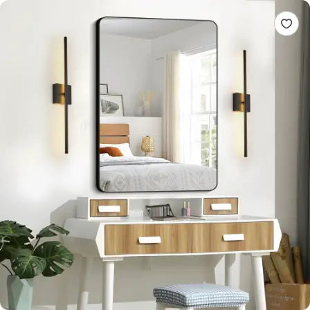 Rectangular wall-mounted mirror with a sleek black frame and minimalist design paired with modern dimmable black matte led wall sconce 2-pack.