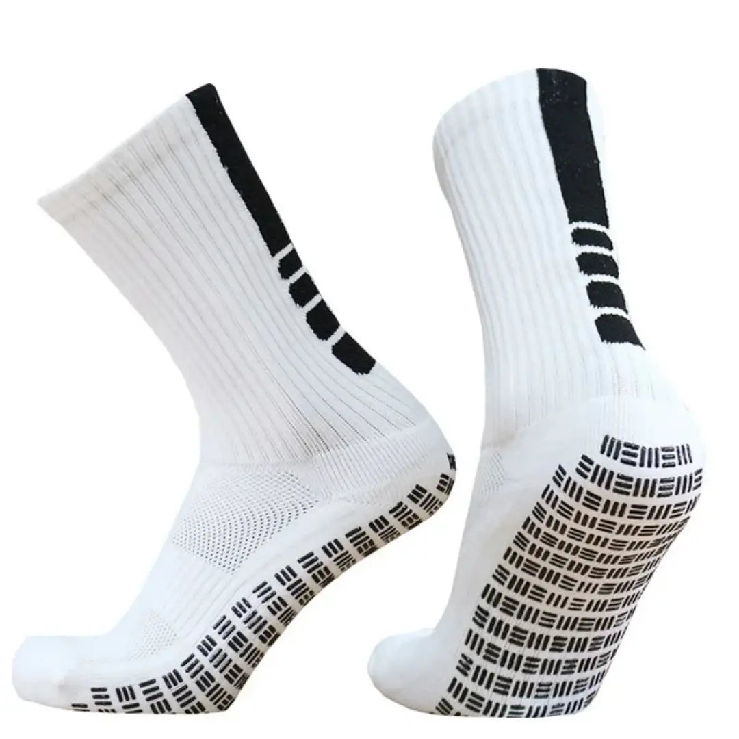 White grip soccer socks with black non slip sole patterns and a vertical stripe on the side designed for athletic use shown from the back side.