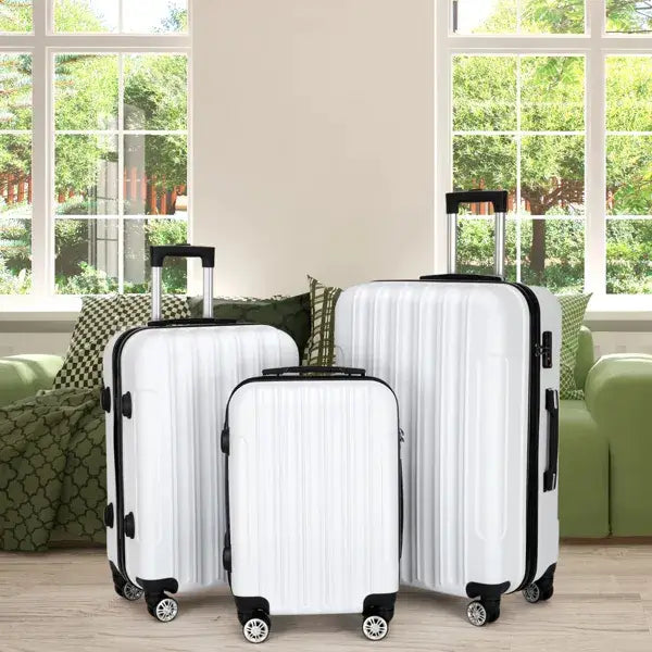 Set of three white hard-shell spinner suitcases with black trim and wheels in a 3 piece luggage set.