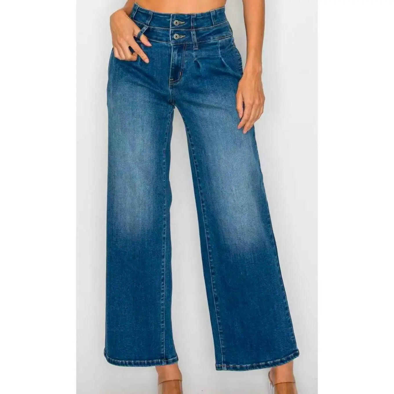 Medium blue wide leg denim jeans featuring high-waisted design, button closure, and subtle fading on blue denim material.