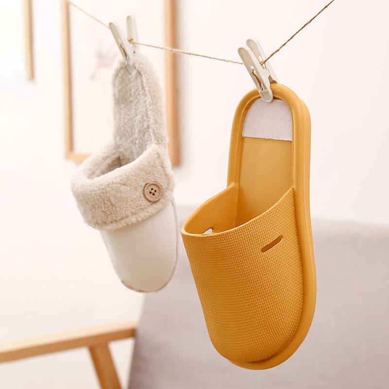 Yellow textured washable plush slip-on house slipper for women with a white adhesive strip on the back and a small cutout near the toe shown from the back side.