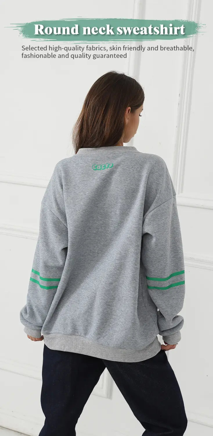 Gray oversized heart pattern graphic sweatshirt with a round neck and green stripes on the sleeves.