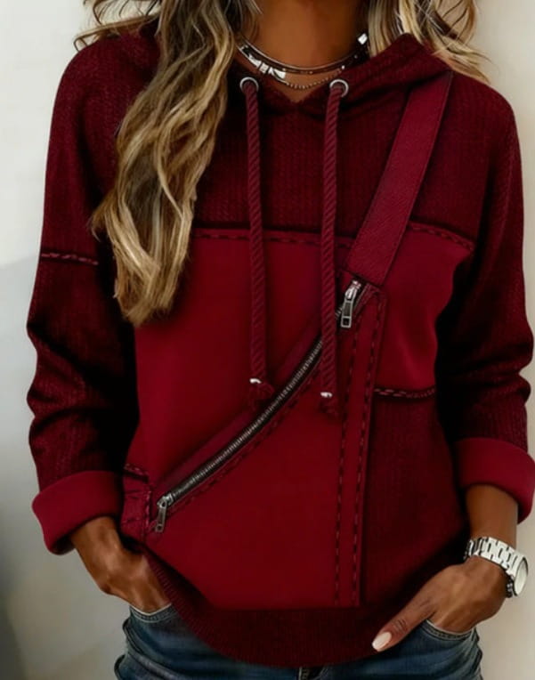 A maroon women 3d patchwork hoodie featuring a hood, diagonal zipper pocket, and contrasting stitching details.