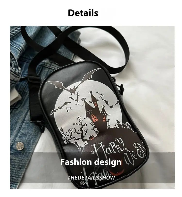 Black embroidered Halloween floral and pumpkin crossbody bag featuring a spooky castle, bats, and happy wecan text in white with red accents for festive use.