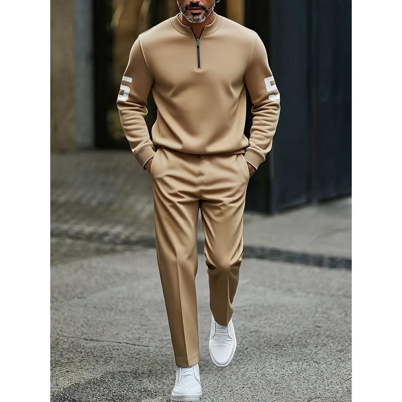 beige half zip athletic sweatsuit printed set featuring white numerals on the sleeves designed for active wear