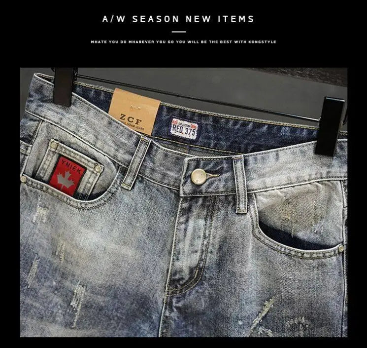 Distressed maple leaf denim shorts in light-wash faded blue with a red maple leaf patch on the front pocket and branded zcf tags.