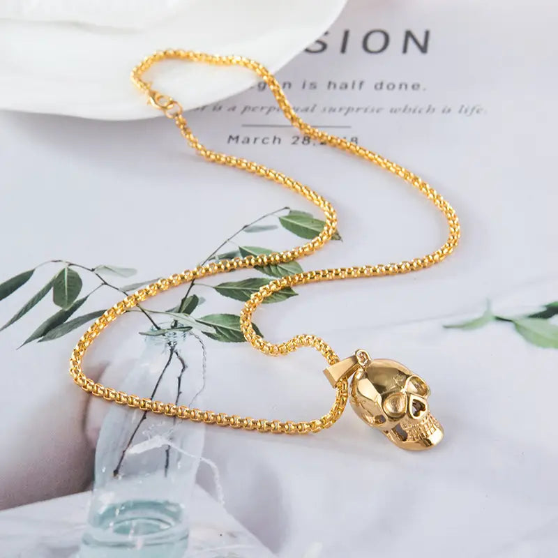 Gold-colored punk skull pendant necklace with a textured titanium steel chain for men and women.
