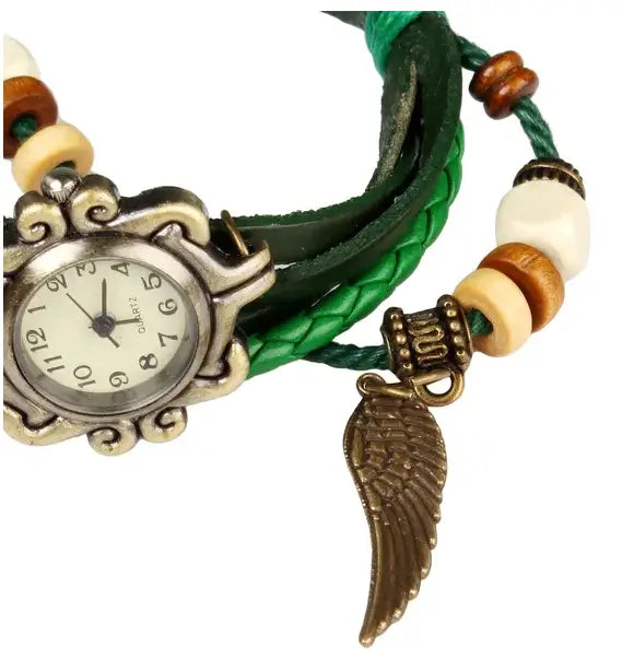 Bohemian green braided leather wristwatch with an ornate silver toned case and a dangling bronze angel wing charm.