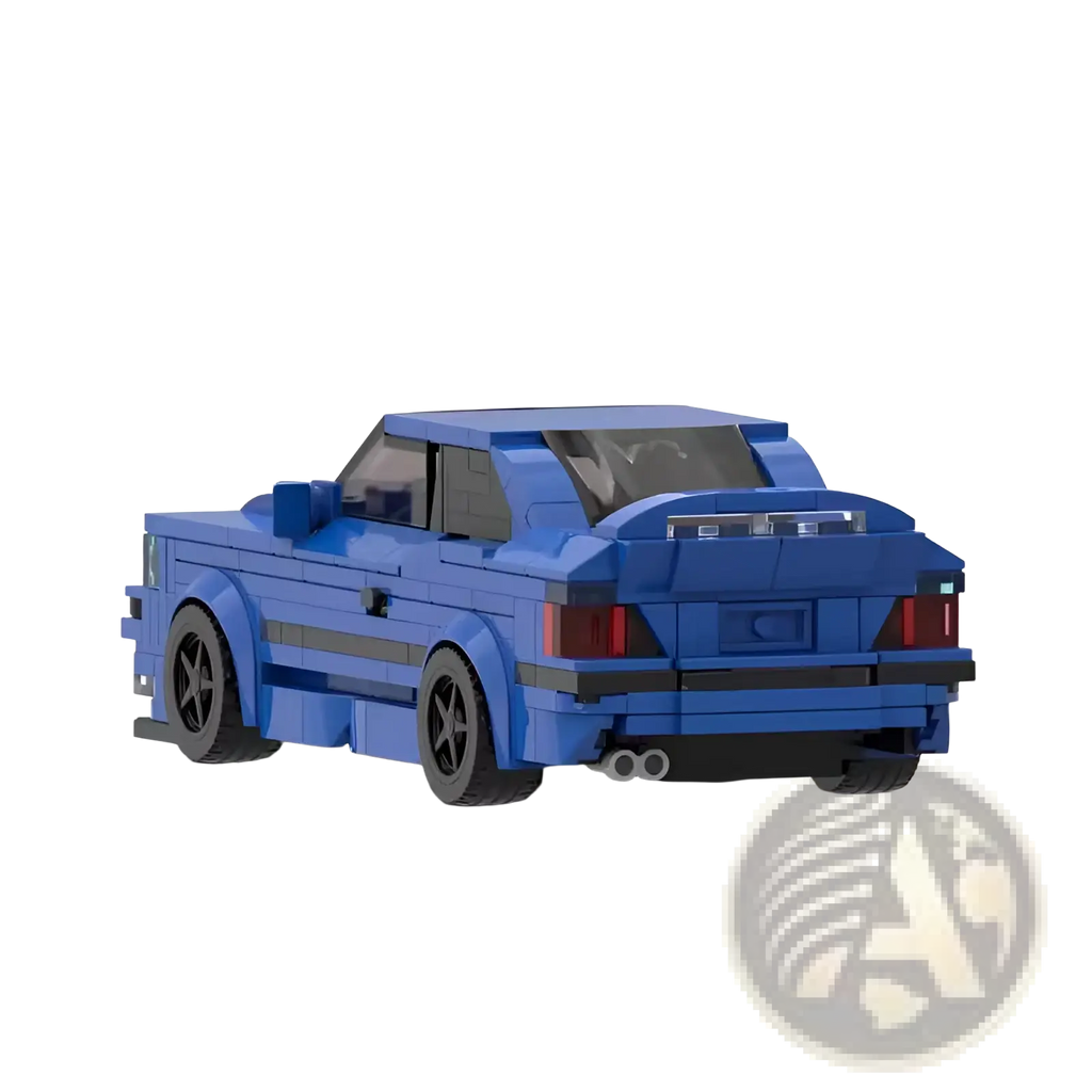 Blue lego-built e36 sports car model with black wheels and red taillights showing the back side view