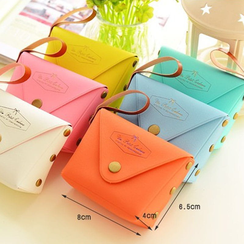 A vibrant orange leather envelope-style pouch with a brown leather strap and gold-tone button closures from the macaron pastel leather and pvc coin purse set.