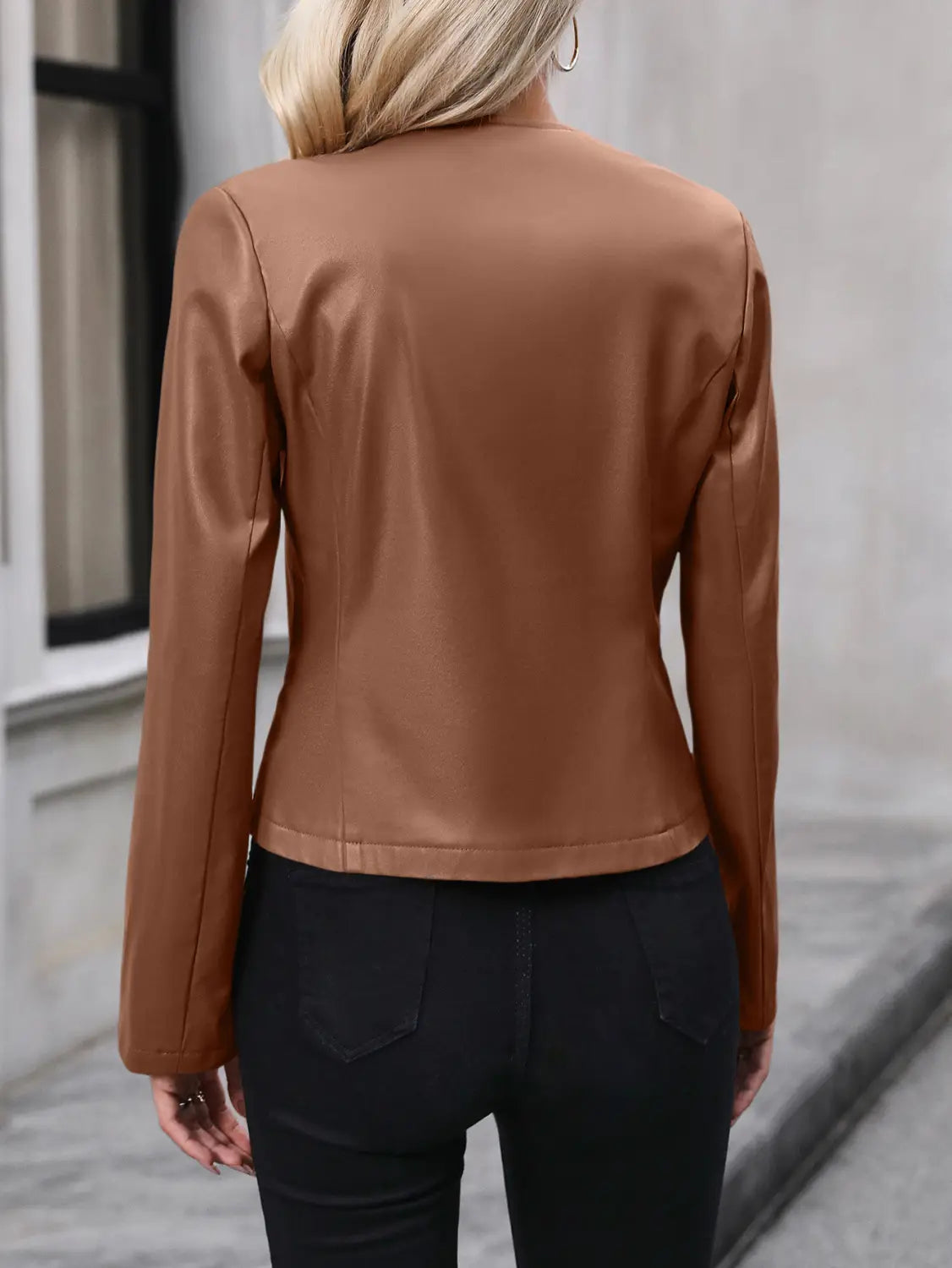 A sleek tan faux leather moto jacket with a fitted silhouette and long sleeves designed as women’s faux leather bomber jacket long sleeve outwear.