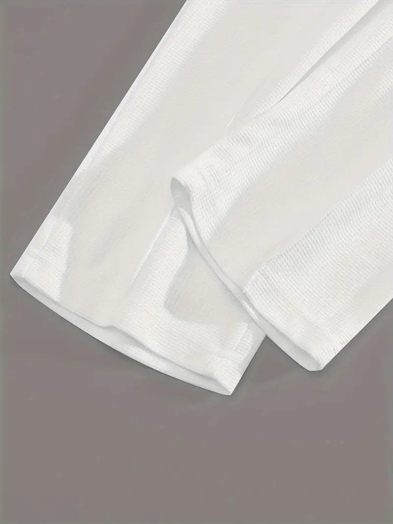 mens minimalist solid color sweatshirt jogger set made of white cotton fabric with a subtle textured weave folded neatly to showcase its clean finish