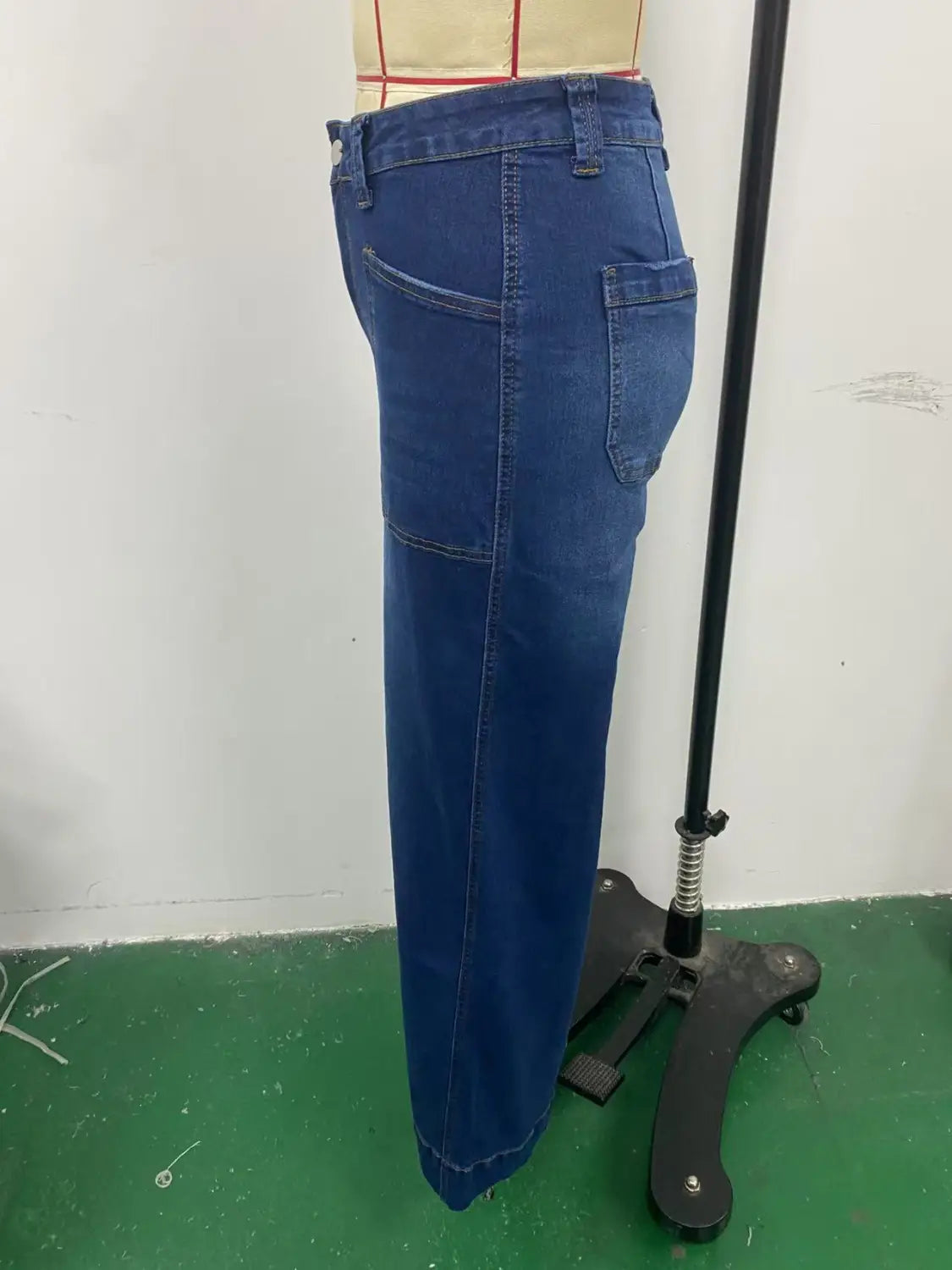 Blue denim wide leg pants with belt feature straight-leg cut and visible stitching details.