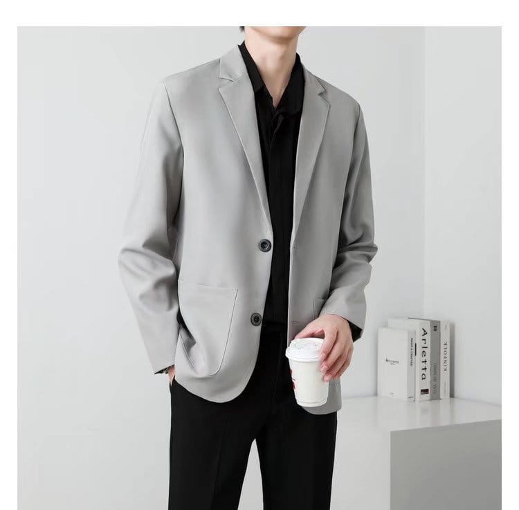 A sleek light gray men slim fit two button blazer with a modern cut and black buttons.