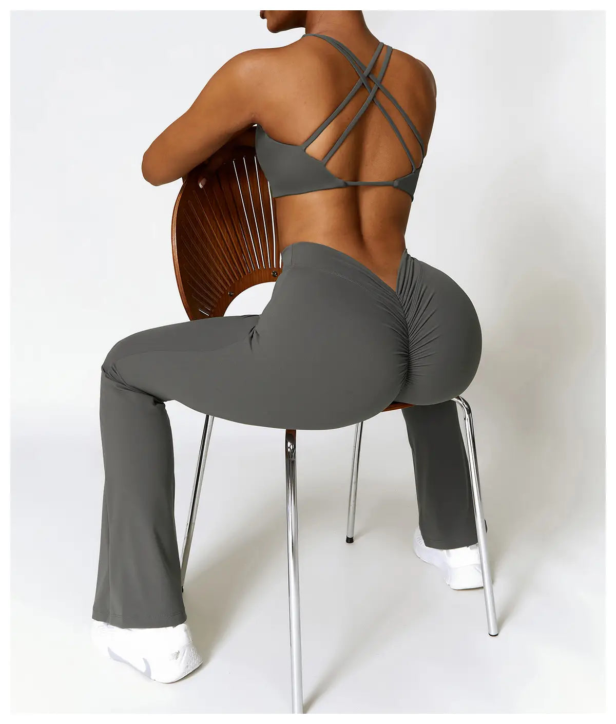 gray high-waist flared yoga pants with a ruched back design ideal for activewear and athletic use shown from the back side