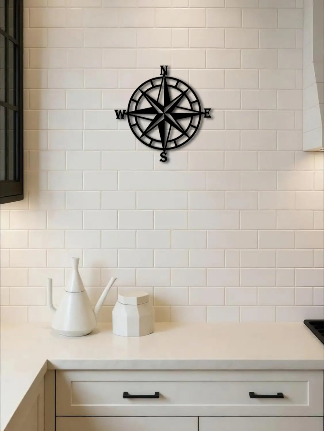 Black metal nautical compass wall art featuring cardinal direction markers measuring 11 inch for decorative use.